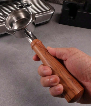 54mm-bottomless-portafilter-redwood-handle-extractionphoto-personhandholding